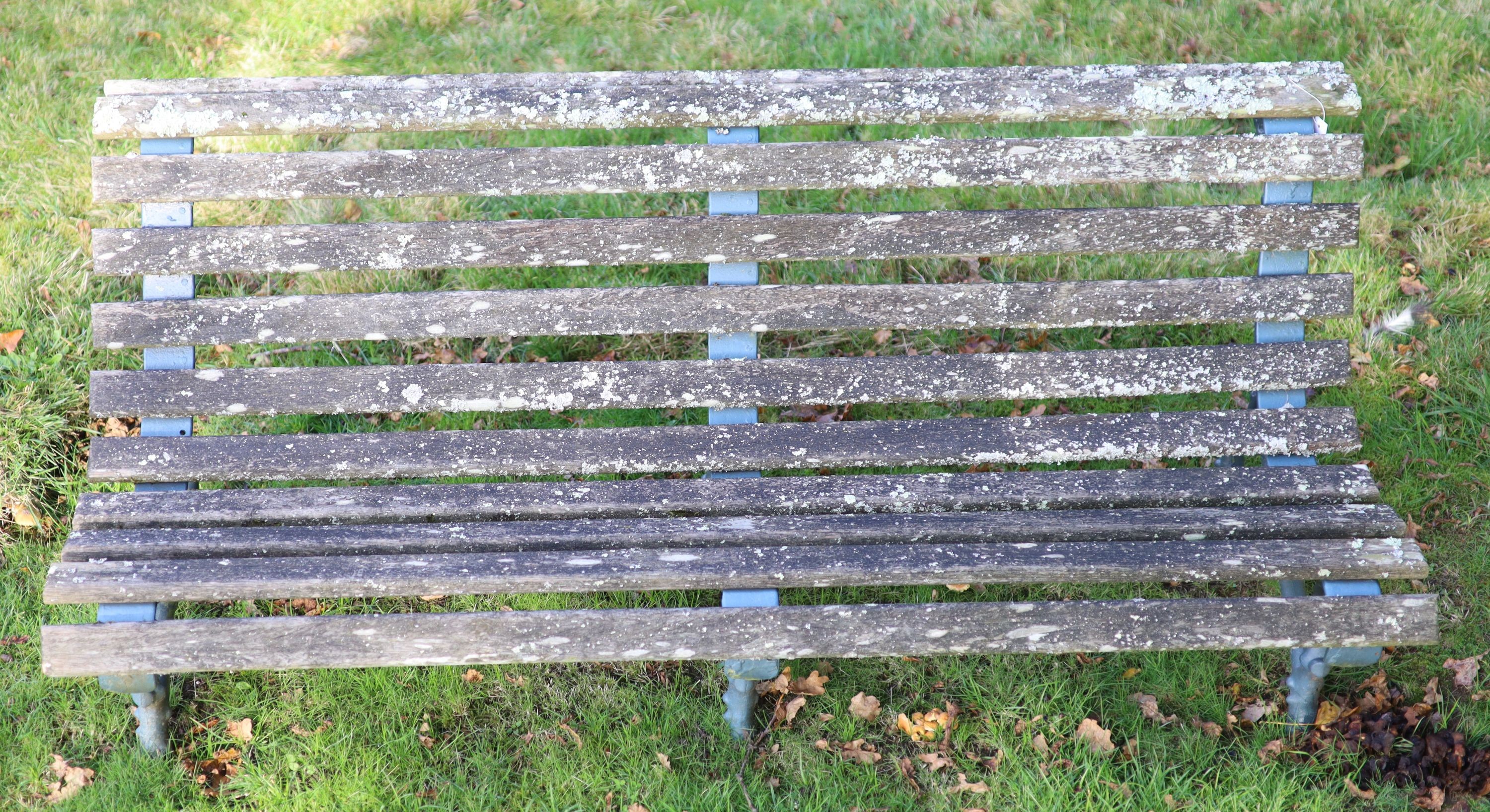 A pair of Coalbrookdale style cast iron and slatted teak garden benches, width 165cm depth 77cm height 60cm